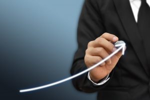 Businessman drawing arrow on screen graph corporate future growth plan. Concept of business development and growth.